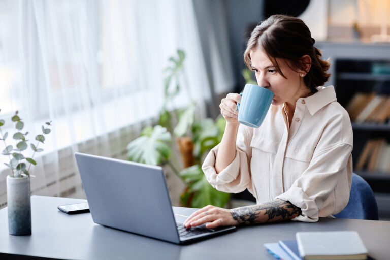 Tattooed Woman Working from Home